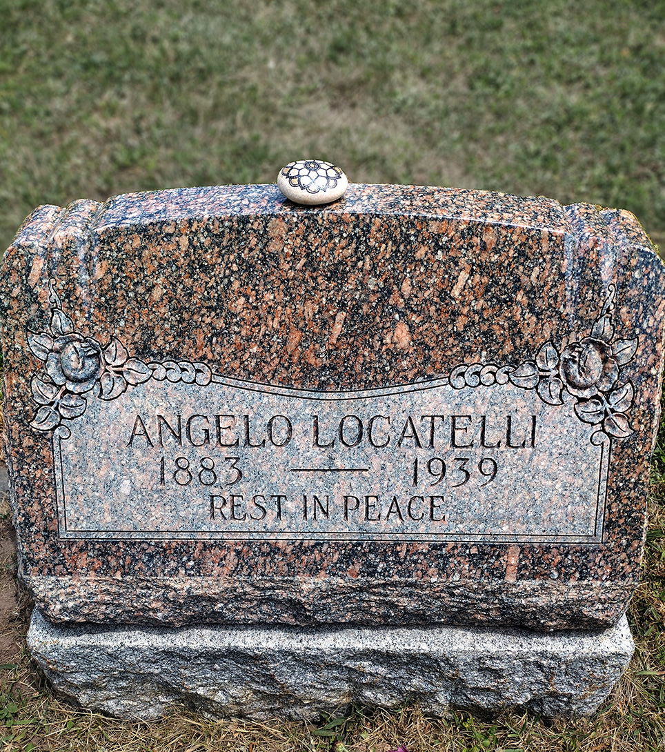 Angelo Locatelli's gravestone at Mt. Olivet Cemetery with the painted memorial rock resting on top