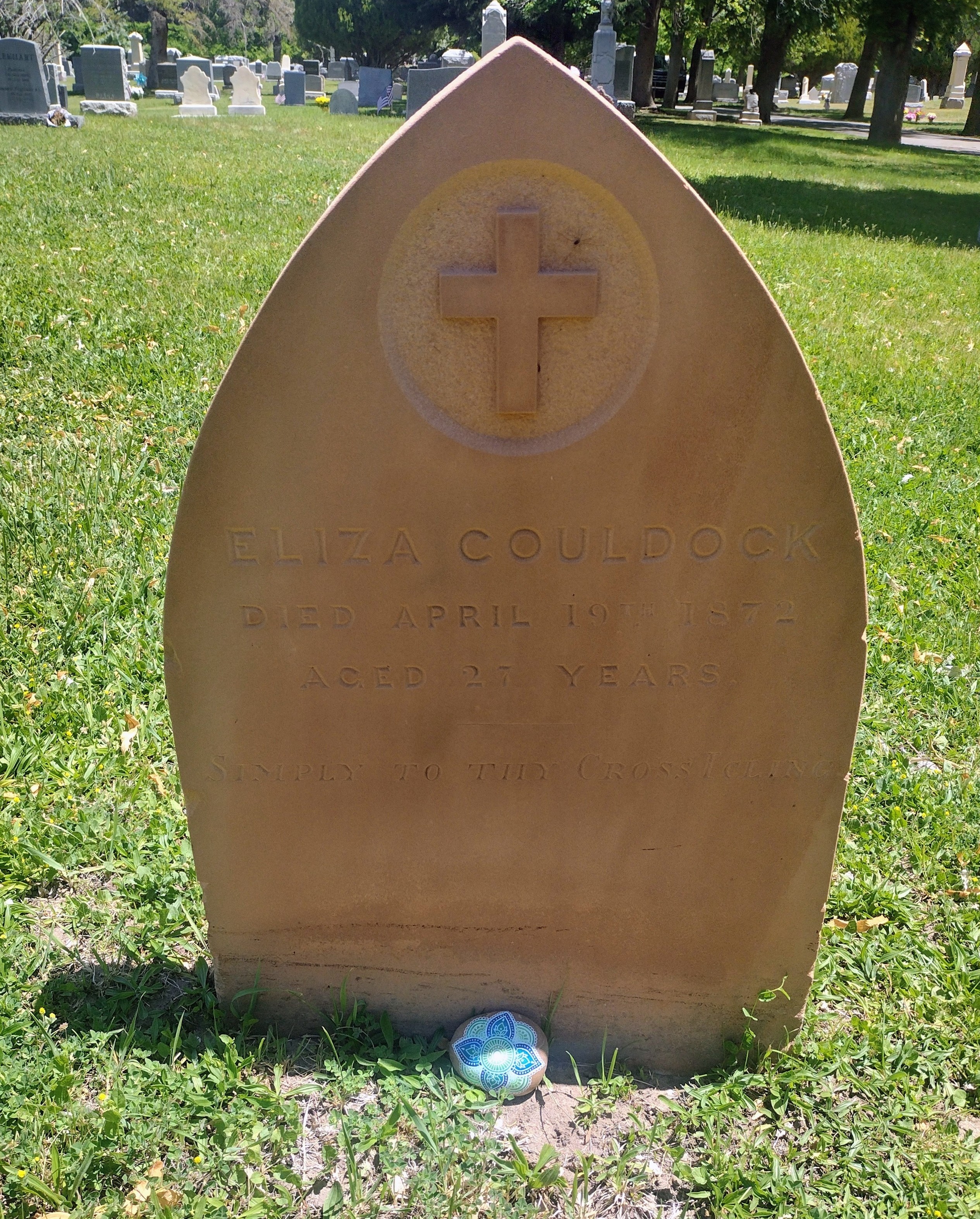 Eliza Couldock's gravestone with the painted memorial rock placed at its base