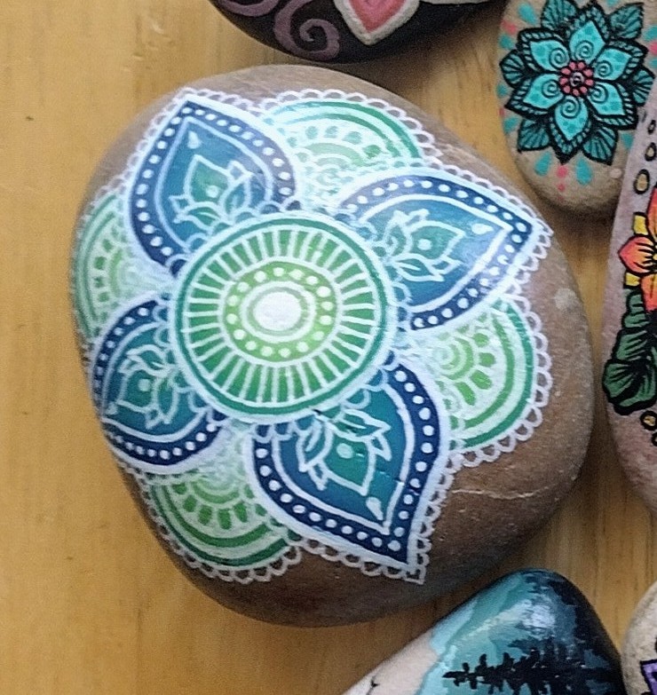 Eliza Couldock's painted memorial rock among other Memorial Day remembrance stones