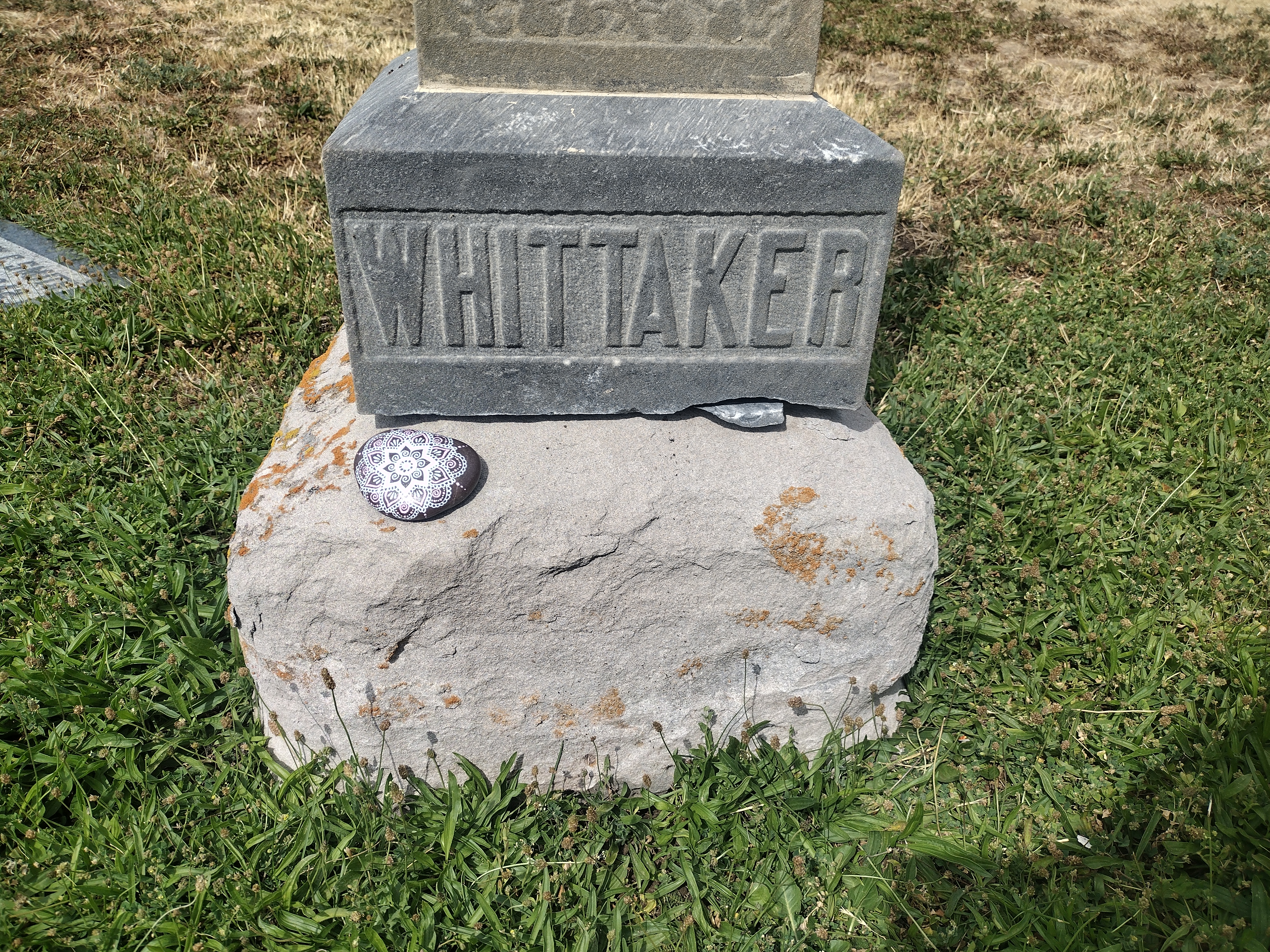 Memorial rock placed at the base of the Whittaker gravestone in Mt. Olivet Cemetery